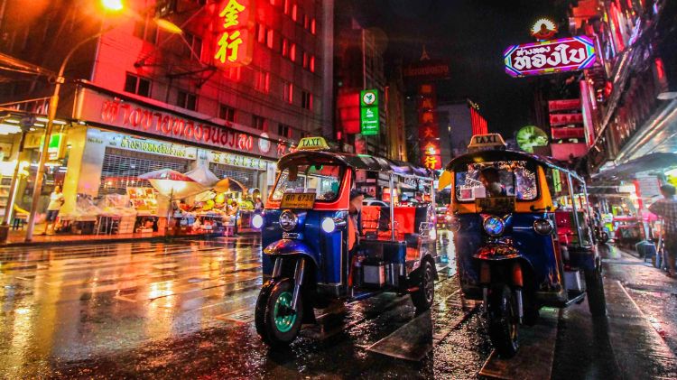 Tuk-tuk dans les rues animées de Bangkok, symbole emblématique des déplacements urbains rapides et typiques