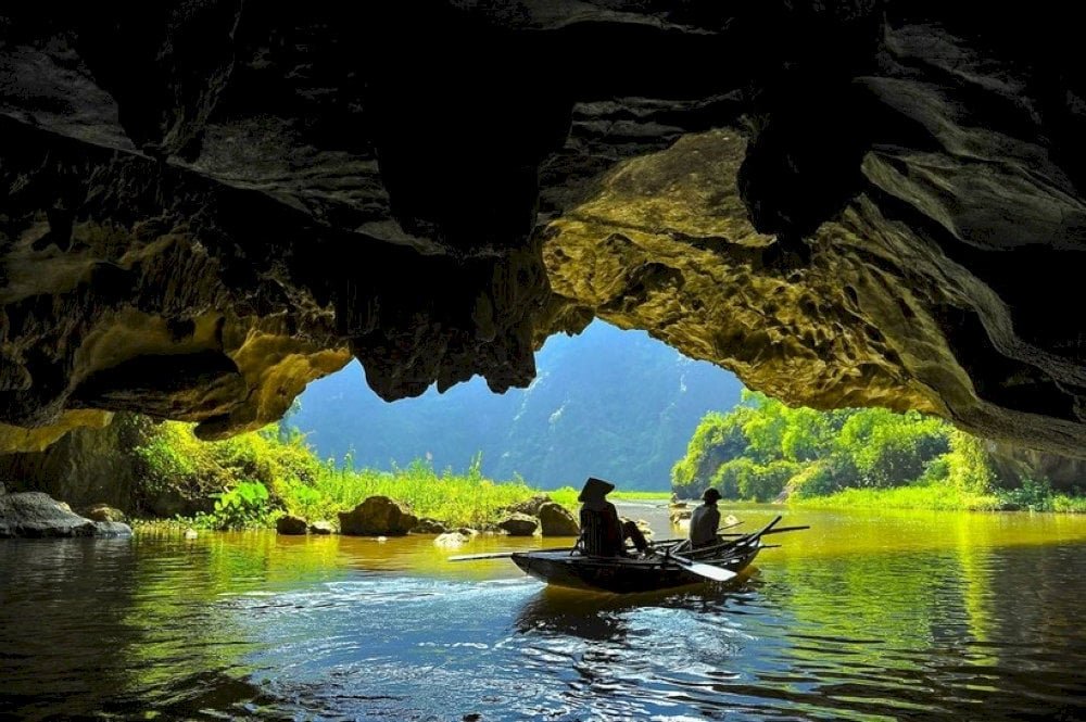 Barques entrant dans une grotte de Tam Coc à Ninh Binh