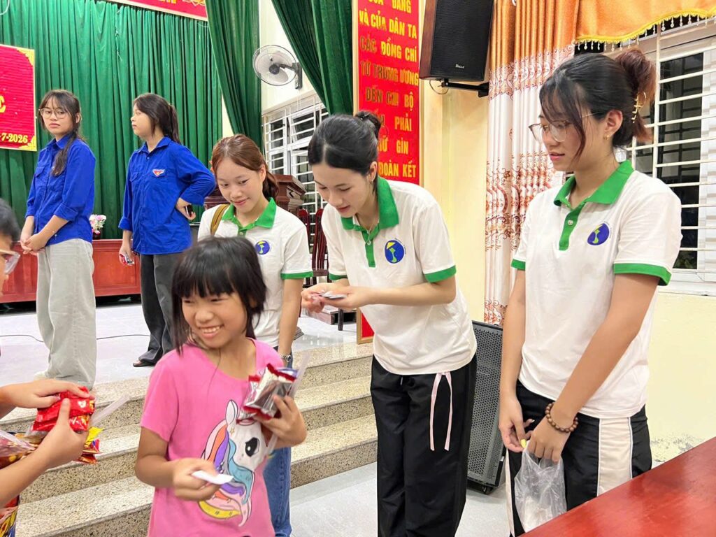 Remise de fournitures scolaires à une jeune fille par l'équipe Horizon Vietnam Travel, campagne Hạ Chí 2026