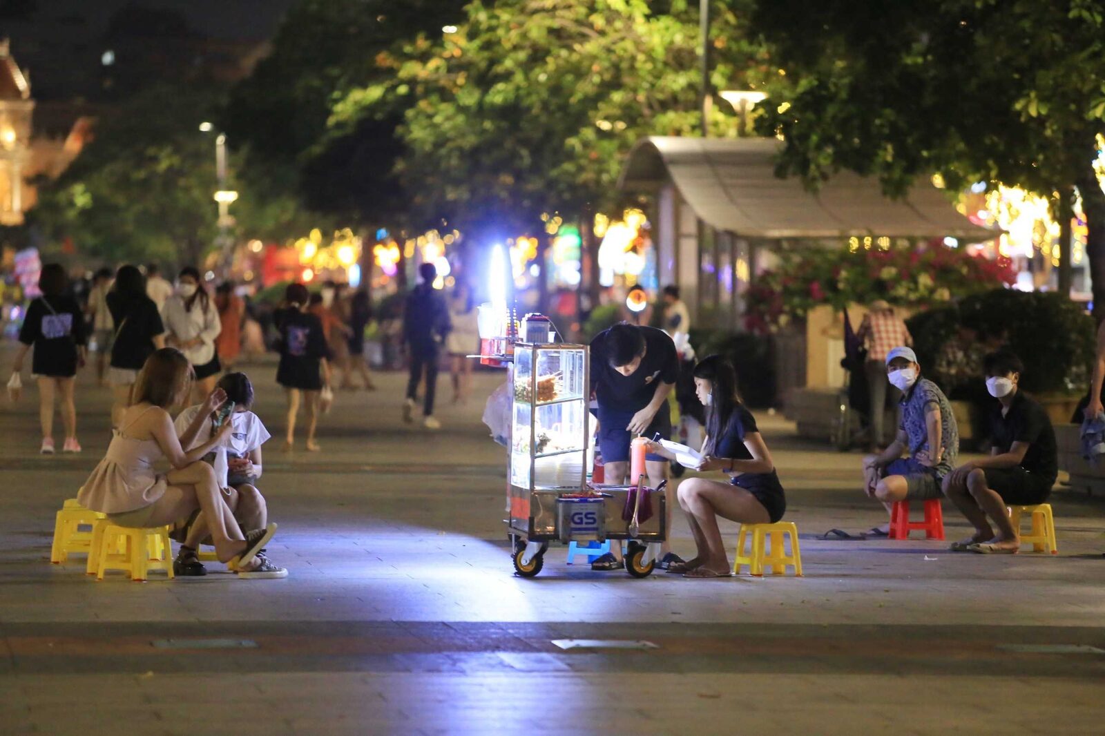 Stand de street food sur la rue pietonne Nguyen Hue le soir