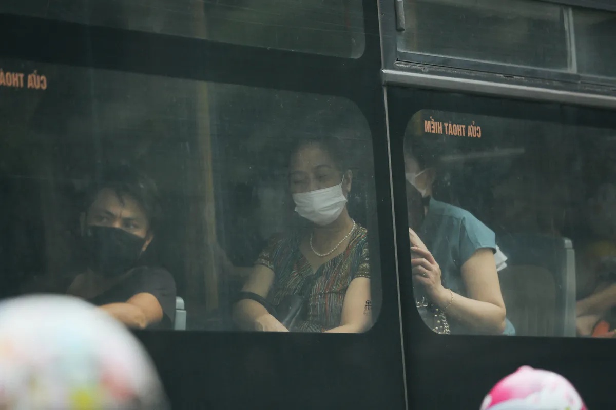 Passengers wearing masks inside a bus in Vietnam