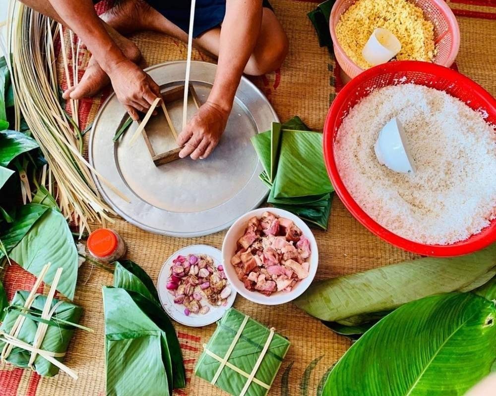 Pliage traditionnel du banh chung à l'aide de feuilles de dong et de lanières de bambou